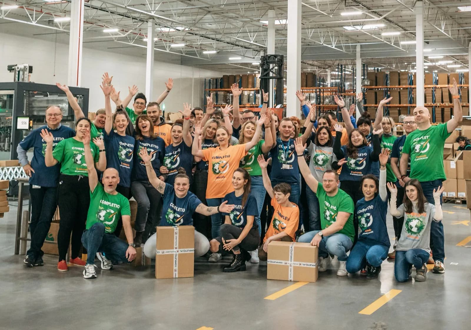 Completio employees posing together in the warehouse hall