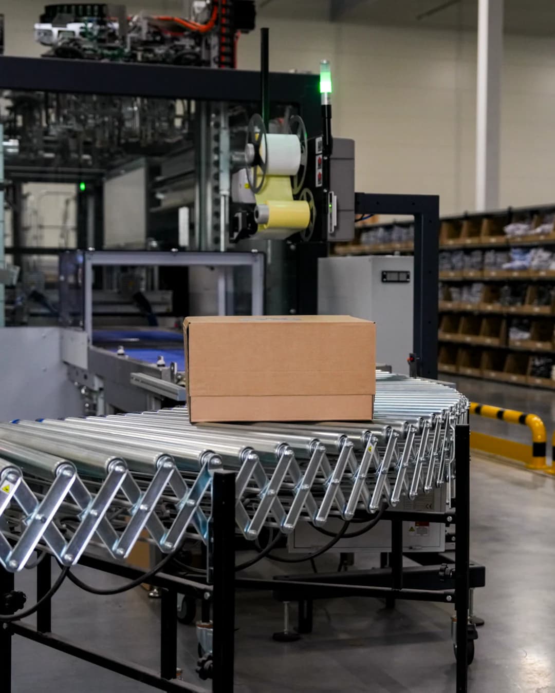 A carton on a roller conveyor at the labelling machine of the packing line
