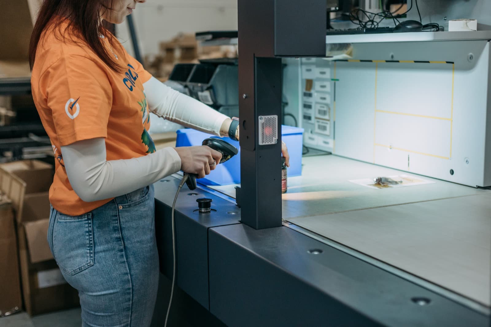 A Completio employee scanning a product at the packing machine